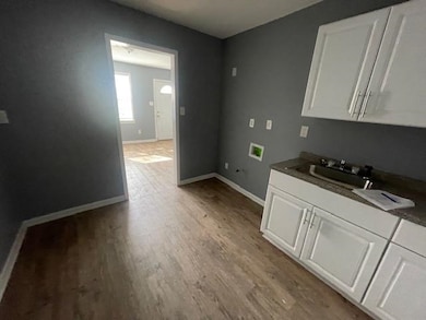 Washroom with washer hookup, light hardwood / wood