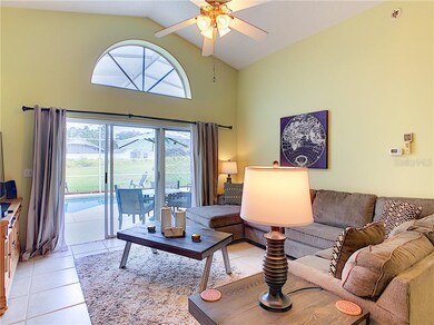 Living area with pool views and lots of natural li