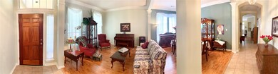 Panoramic view of formal living and formal dining areas.