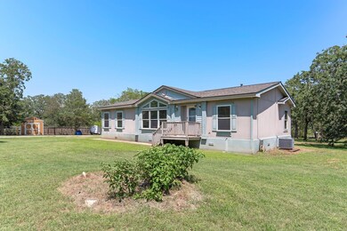 Back of house with central air condition unit, a 
