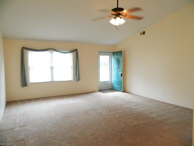Vaulted Great Room with Ceiling Fan and Window Tre