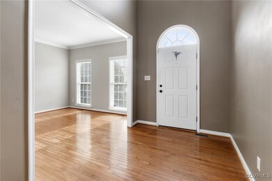 Entryway featuring light wood-type flooring, crown