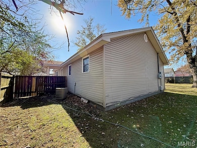 View of side of home featuring a central AC unit and crawl space