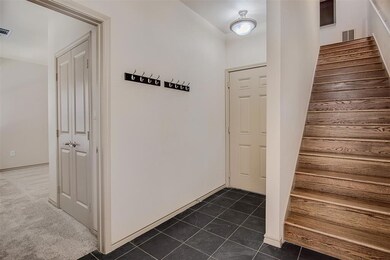 Entryway, bottom floor bedroom and garage access.
