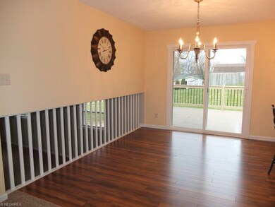 Dining room with new flooring is open to the kitch