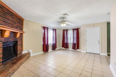 Large Living Space with Brick Fireplace and Tile f
