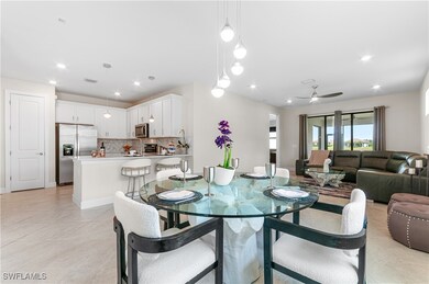 Dining space featuring ceiling fan, light tile pat