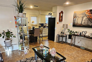 Living room featuring visible vents and recessed l