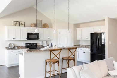 Kitchen with dark wood-type flooring, open floor p