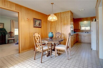 Dining area and kitchen with door to master bedroo