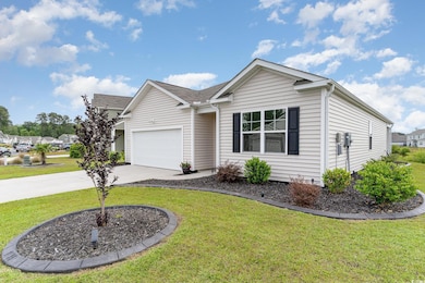 Single story home with driveway, a front yard, a s