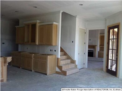 Another wall of cabinets in the kitchen, as seen from keeping area. Conveniently located stairs lead to 2nd floor den and bedrooms.