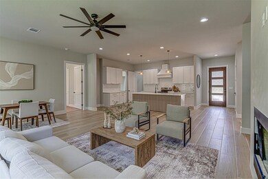 Living area featuring baseboards, a ceiling fan, 
