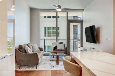 Living room with ceiling fan, wood finished floor