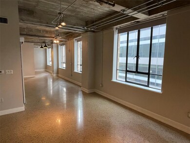 Spare room with baseboards and speckle patterned floor