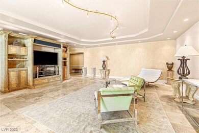 Living room featuring a tray ceiling, recessed lig