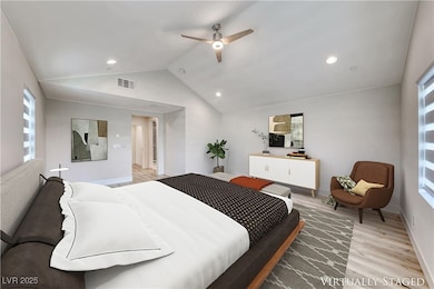 Bedroom featuring light wood-style floors, vaulted