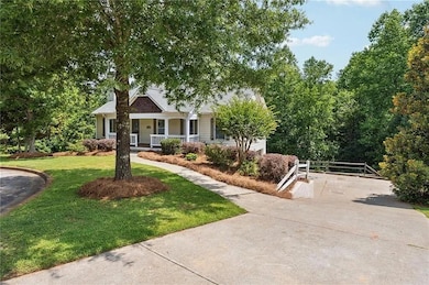 View of front of house with covered porch and a front lawn
