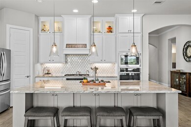 Kitchen with arched walkways, appliances with sta