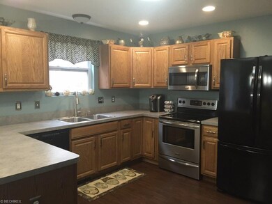 Open kitchen with laminate flooring, recessed ligh