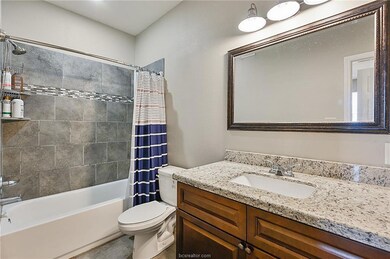 Bathroom featuring toilet, shower / bath combo wit