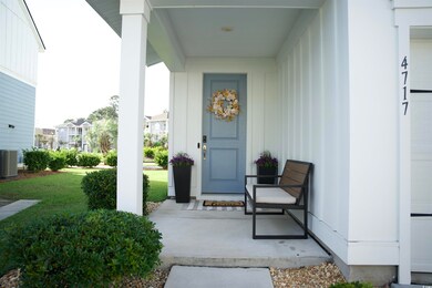 View of front entry with lawn and large porch