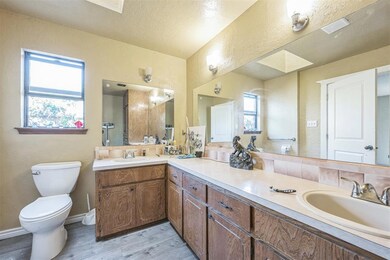 Bathroom featuring vanity, hardwood / wood-style f