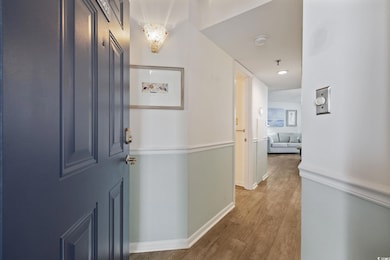 Corridor featuring wood finished floors and baseboards