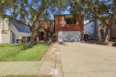 Traditional home featuring brick siding, driveway