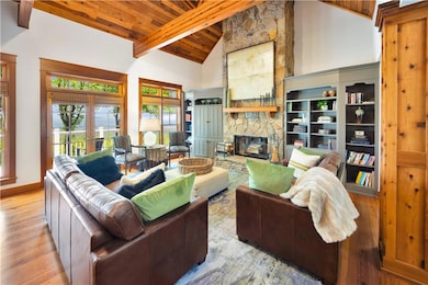 Living area with wood ceiling, a stone fireplace, 