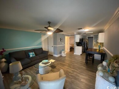 Living room featuring crown molding, ceiling fan, 
