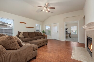 Main living area with gas fireplace, high ceilings, upgraded wood/tile flooring, large TV nook, easy access to the covered patio in the back, pool area and the 