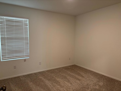 Spare room featuring carpet flooring and baseboar