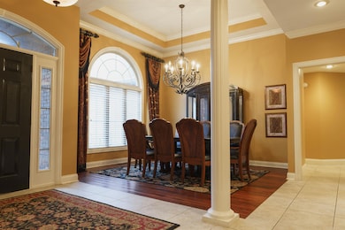 Arched window, beautiful floors, custom chandelier
