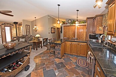 The main floor kitchen features stunning slate flo