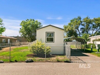 View of side of home with a carport and driveway