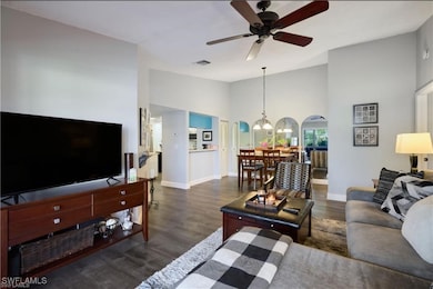 Living area featuring a chandelier, ceiling fan, b