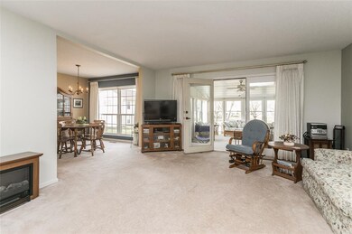 View from entry door into living room, sunroom and