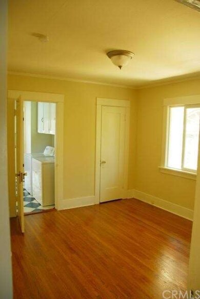 Center bedroom with large closet wood floors throu