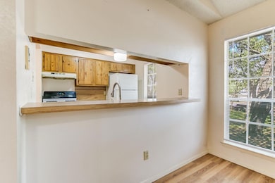 Kitchen featuring stove, freestanding refrigerato