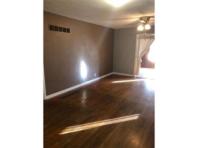 Large living room with hard wood floors!