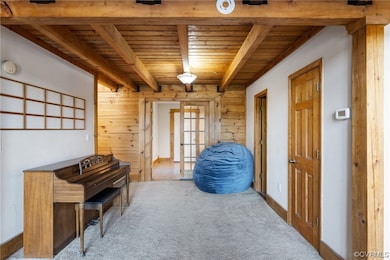 Misc room featuring wooden ceiling, light colored