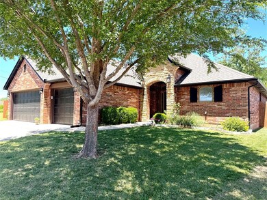 View of front of property with brick siding, a front lawn, an attached garage, and concrete driveway