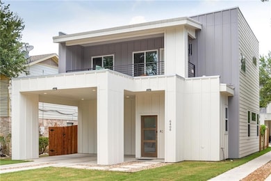 Rear view of house with a balcony, board and batt