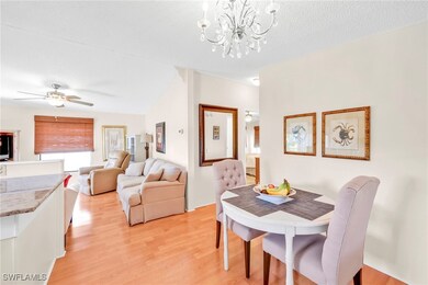 Dining space with ceiling fan with notable chandel