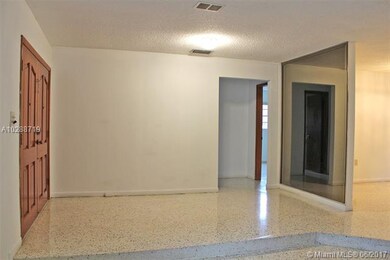 Foyer entrance to the home with refinished terrazz