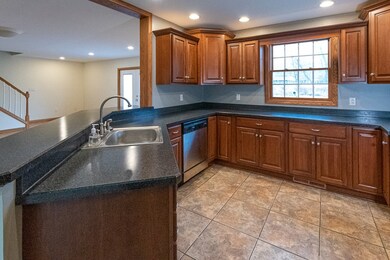Kitchen has a tile floor, dishwasher, microwave ov