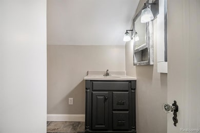Bathroom with vanity and baseboards