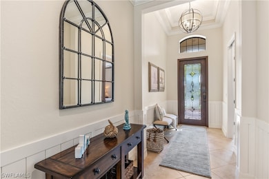 Entryway with an inviting chandelier, ornamental m