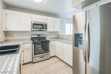 Kitchen featuring appliances with stainless steel
